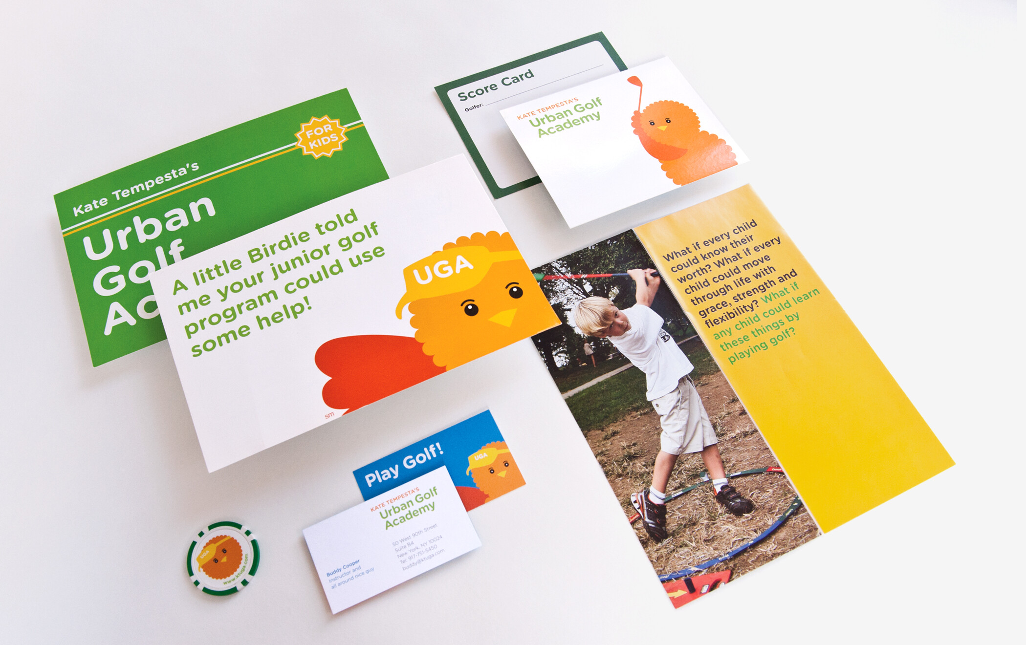 A variety of Urban Golf Academy marketing materials, including postcards, business cards, and a branded golf scorecard.